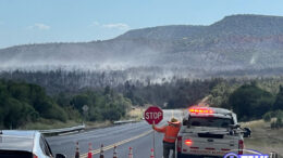 Motorist wait for pilot car to escort them through the area effected by the Flying V Fire on on Hwy 60 near Cibecue, AZ